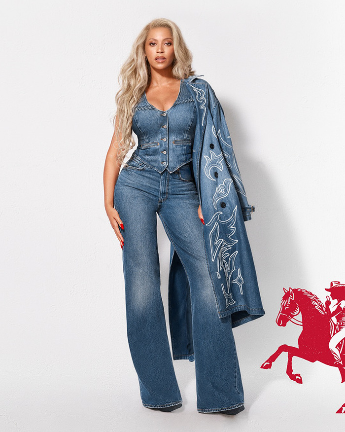 Beyoncé posing in a denim outfit including vest, wide-leg jeans, and embroidered denim coat in a fashion ad. - 7