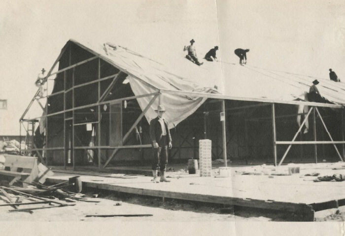 Construction workers building a wooden structure during the birth of Vegas in historic early 20th century photos.
