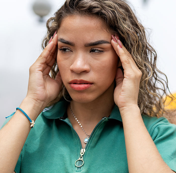 Woman looks frustrated and stressed during a neighbors fight over driveway dispute and taking what belongs to her.