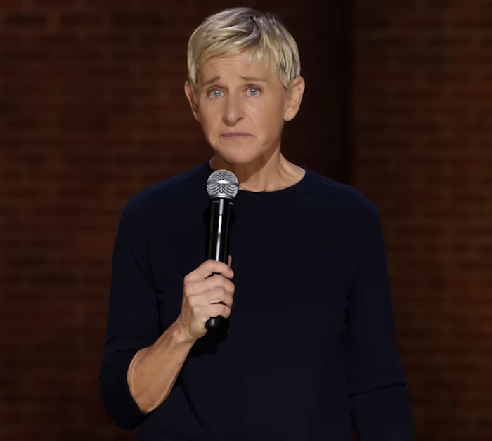 Ellen DeGeneres holding a microphone on stage, looking serious amid the bullying controversy and new claims. Ellen DeGeneres holding a microphone on stage, looking serious amid the bullying controversy and new claims.