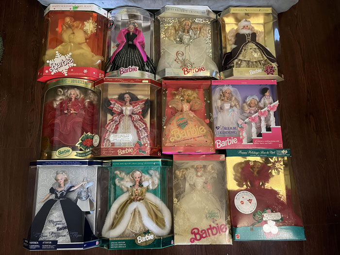 Collector Barbie dolls in original packaging displayed on wooden floor, highlighting valuable collectibles and careful preservation. - 5