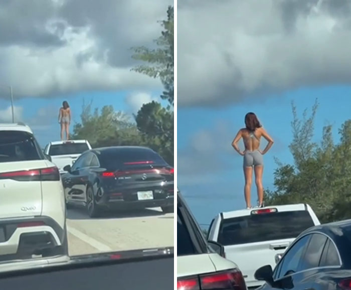 Woman standing on a car roof in traffic, showing blatant disregard for rules and etiquette on a busy road.