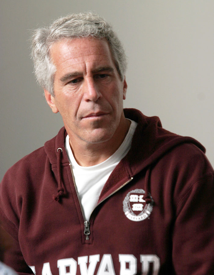 Man in a Harvard sweatshirt looking down thoughtfully, representing doubts about Epstein jail video missing minutes. - 1