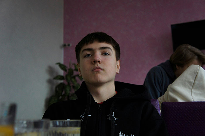 Teen boy with serious expression indoors, representing effects of lazy parenting turning kids into walking nightmares. Teen boy with serious expression indoors, representing effects of lazy parenting turning kids into walking nightmares.