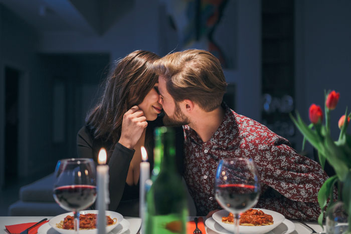 Couple sharing a tender moment over dinner, illustrating themes of betrayal and giving a taste of her own medicine in friendship conflicts. - 17