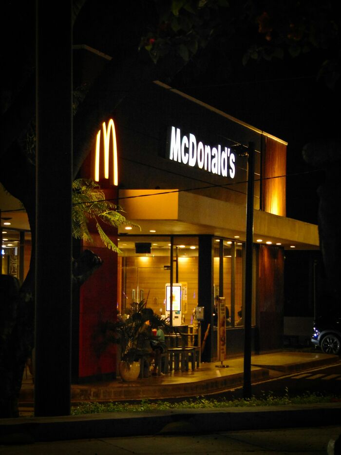 McDonald's restaurant lit up at night showing new facts about popular fast food chains for learning enthusiasts.