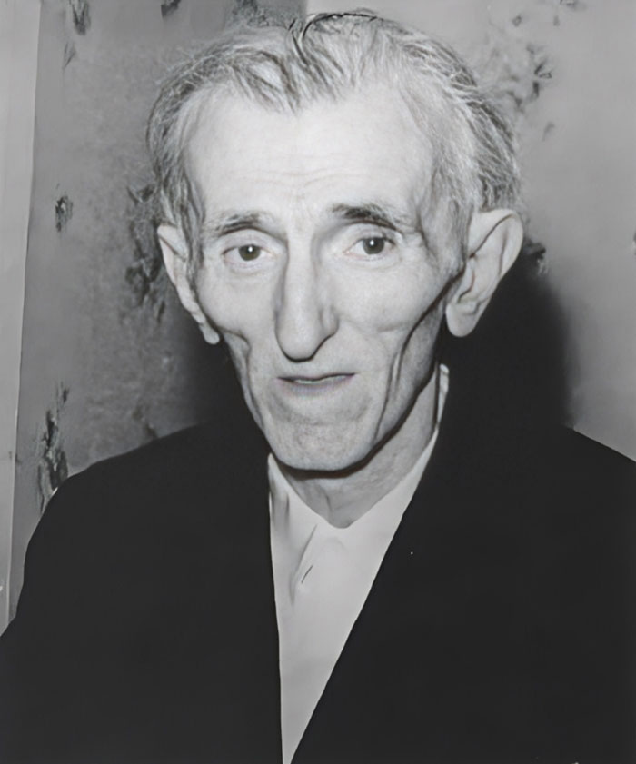 Black and white historical photo of a thin elderly man with distinct facial features and deep wrinkles.