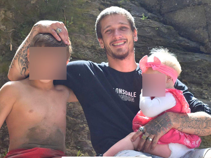 Young dad with two children smiling outdoors, related to tragic sand digging accident and buried alive incident.