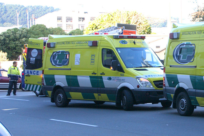 Yellow Wellington Free Ambulance vehicles parked on a street during emergency response to buried alive sand digging incident.