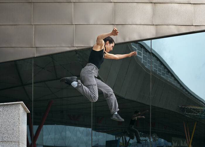 Person demonstrating impressive physical agility in mid-air jump, highlighting cool facts about the human body.
