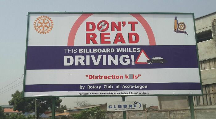 Billboard warning about distraction while driving, illustrating funny advertising fails and unattainable body portrayed in advertising.