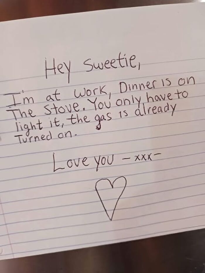 Handwritten chaotic marriage meme note about dinner on the stove with gas already turned on, signed with love and a heart.