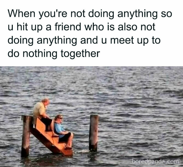Two friends sitting on stairs leading into water, relaxing together in a funny meme about doing nothing, highlighting hilarious memes.