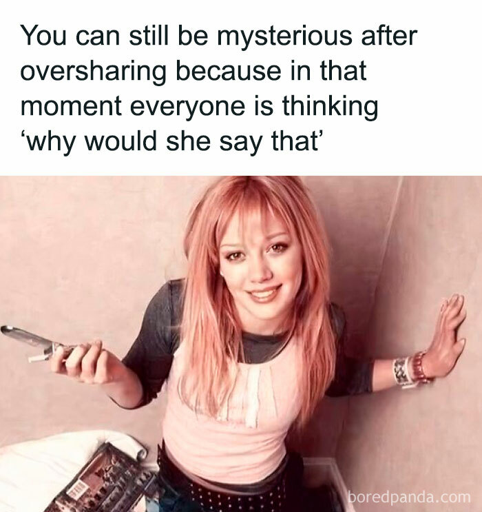 Young woman with pink hair smiling in a corner, relatable meme about oversharing for neurodivergent people.