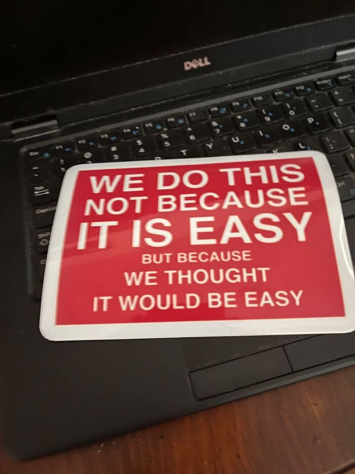 Red and white motivational sticker on a Dell laptop keyboard, relatable to neurodivergent people and their challenges.
