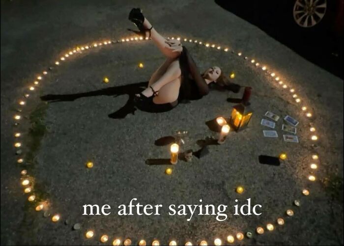 Person lying inside a circle of lit candles with tarot cards nearby, a relatable meme for neurodivergent people.