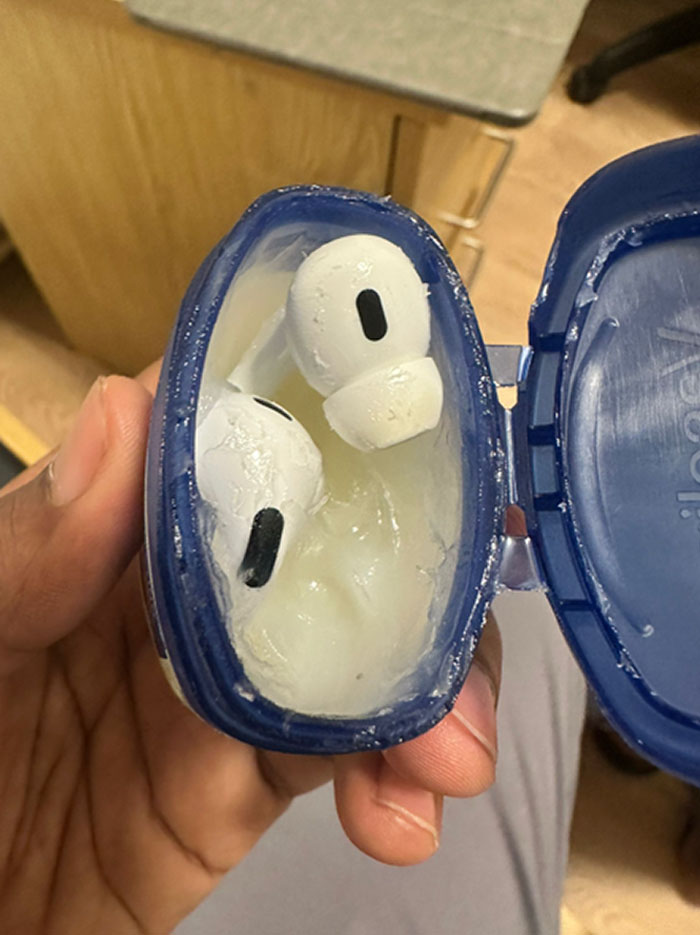 Hand holding AirPods covered in melted substance inside a blue container showing funny ways people learned their lesson.