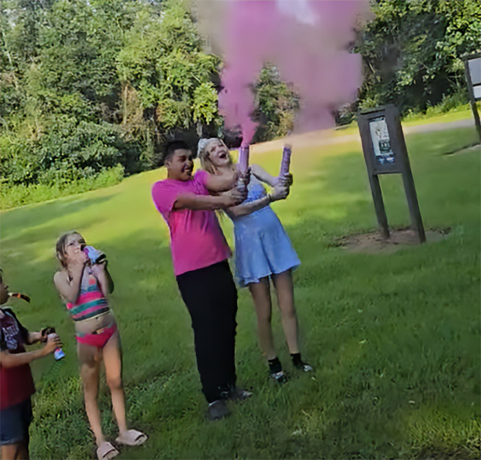 Group of teens outdoors releasing pink smoke with smoke grenades, unrelated to 7-month pregnant teen road rage incident keywords. Group of teens outdoors releasing pink smoke with smoke grenades, unrelated to 7-month pregnant teen road rage incident keywords.