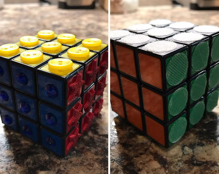 Two Rubik's cubes with real-world designs using textured buttons, stars, and fabric circles for easy tactile solving.