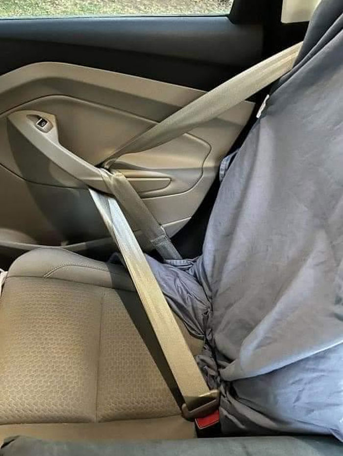 Car seat with a genius life hack showing a seatbelt threaded through the door handle for added safety and comfort.