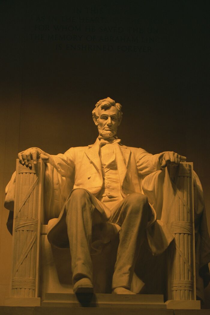 Statue of Abraham Lincoln seated with dramatic lighting, unrelated to Boops Boops fish facts or scientific name.