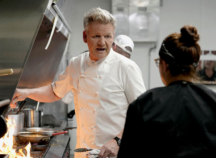 Celebrity chef in a kitchen with flames, reflecting intensity unrelated to Ellen DeGeneres bullying controversy reignited claims. Celebrity chef in a kitchen with flames, reflecting intensity unrelated to Ellen DeGeneres bullying controversy reignited claims.