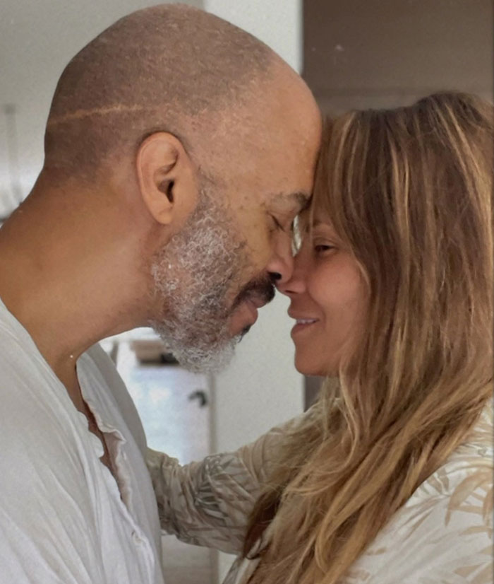 Halle Berry’s ex-husband with a gray beard and woman smiling with foreheads touching in a warm moment. Halle Berry’s ex-husband with a gray beard and woman smiling with foreheads touching in a warm moment.
