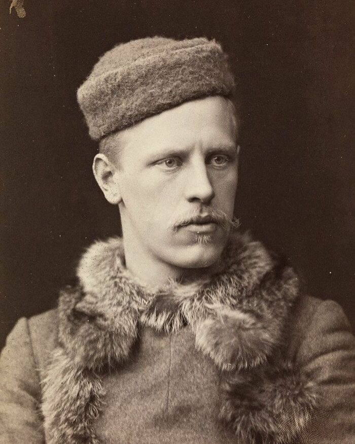 Vintage portrait of a handsome Victorian man wearing a fur coat and hat, showcasing classic 19th-century style and elegance.
