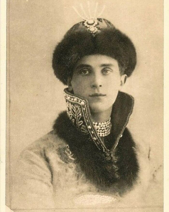 Victorian man in ornate fur-trimmed coat and jeweled hat, a classic example of handsome Victorian men style.