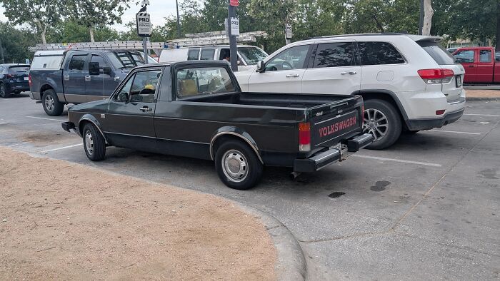Black Volkswagen pickup truck parked in a lot, a vehicle any man would be excited to see in this online thread.