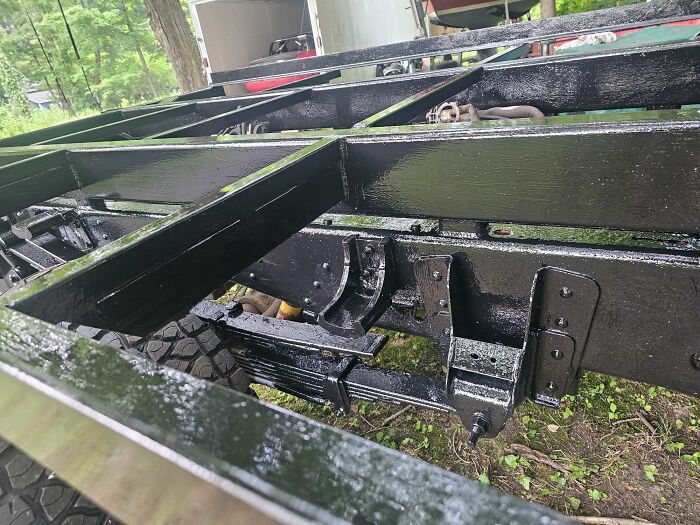 Close-up of a freshly painted black metal vehicle frame, a detail any man would be excited to see.