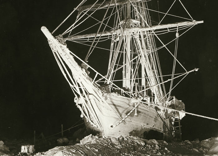Old shipwreck on rocky shore representing unbelievable historical events that people actually survived at sea.
