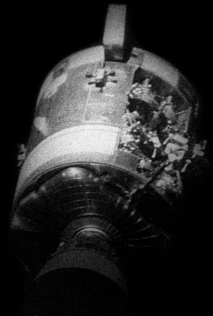 Black and white photo of a damaged spacecraft representing unbelievable historical events people survived in space exploration.