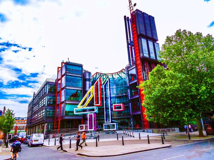 Colorful iconic architectural homes with modern glass facades and vibrant structural elements in an urban setting