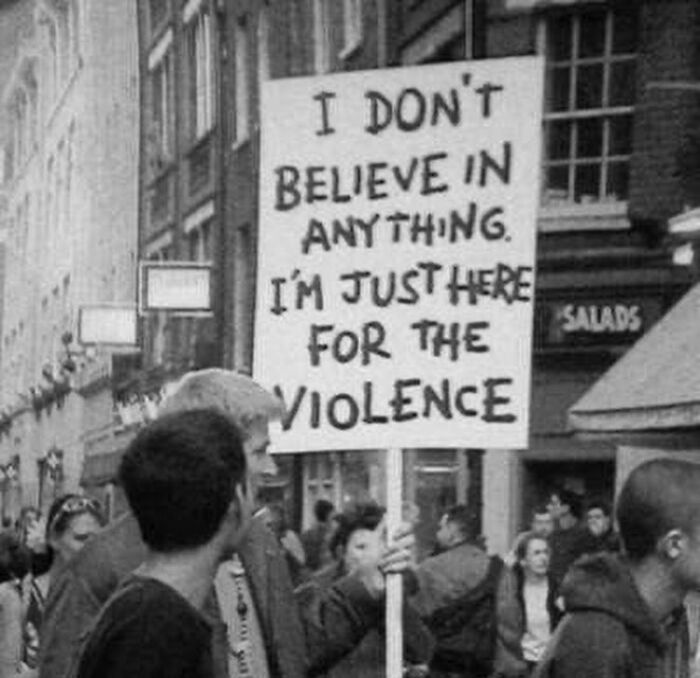 Black and white photo of a person holding a sign at a protest, illustrating weird history pics with unusual messages.