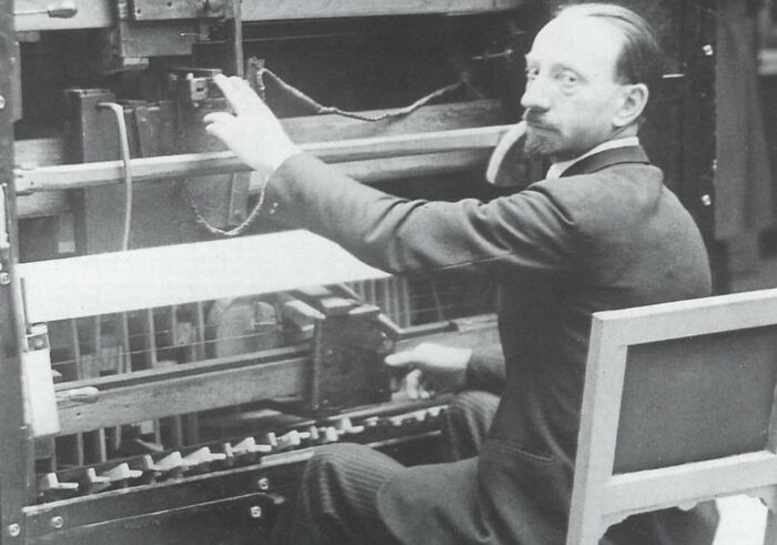 Man operating vintage machine in an early 20th century setting featured in weird history pics.