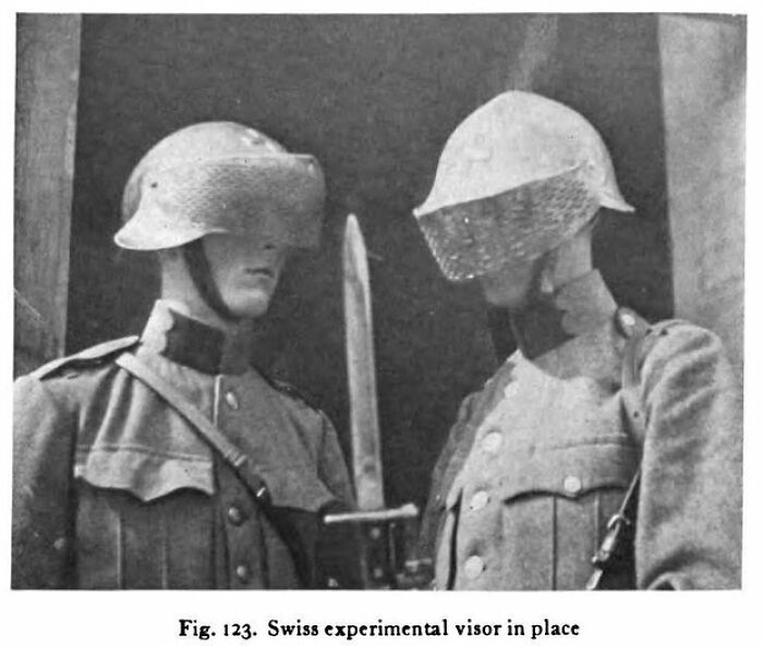 Two soldiers wearing Swiss experimental visors, showcasing weird history gear from early 20th century military experiments.