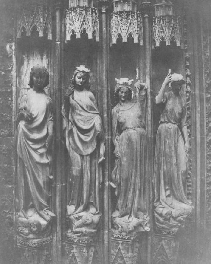 Gothic statues with crowns and robes, showcasing weird history pics from a medieval architectural setting.