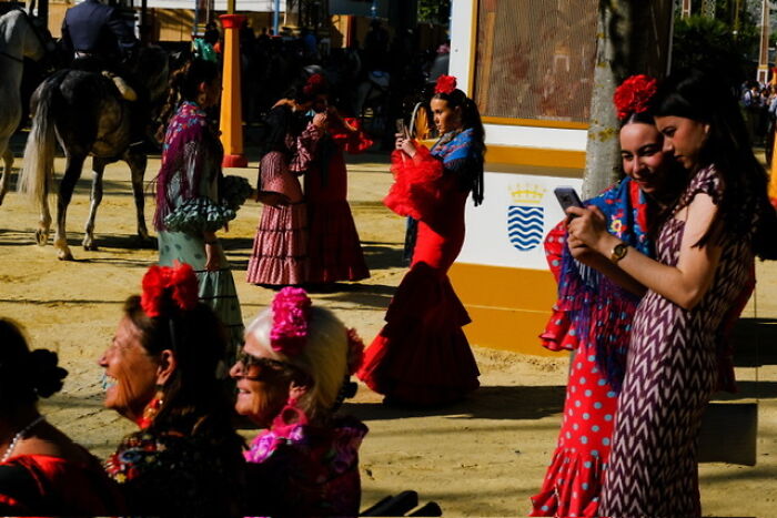 Street photos showing everyday life with people dressed in traditional flamenco dresses outdoors during a sunny day.