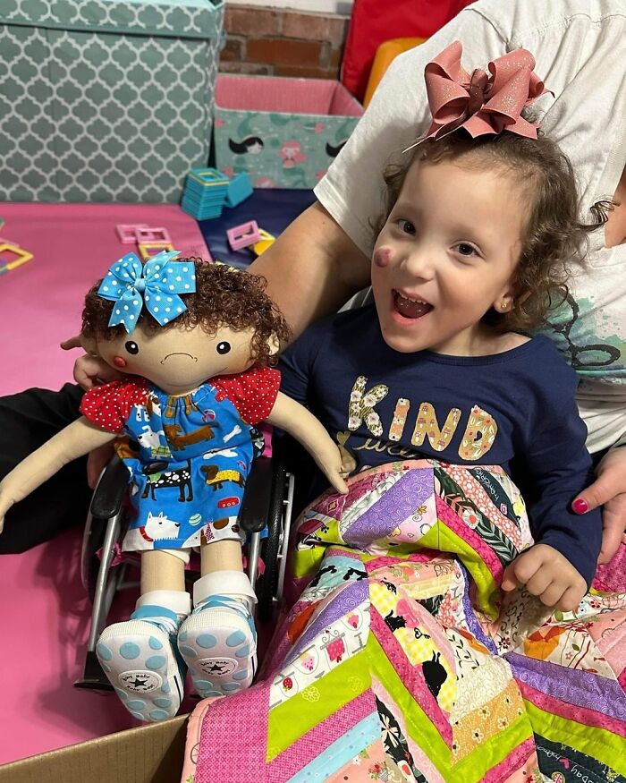 Child holding a doll designed to represent rare health conditions, showcasing personalized dolls for kids with special needs.