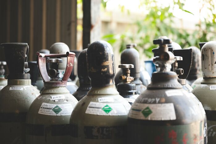 Old gas cylinders lined up indoors in a dimly lit room illustrating disturbing facts that don’t help to sleep at night.