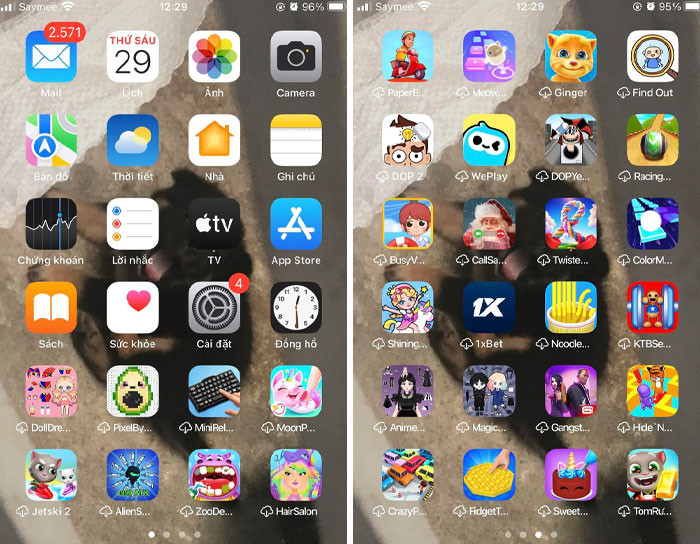 Screenshot of a smartphone home screen showing numerous apps with a blurred dog photo as wallpaper, highlighting sibling shenanigans.