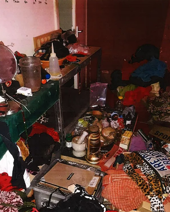 Cluttered room with various household items and clothing scattered, highlighting signs ignored in toddler vegan diet case.