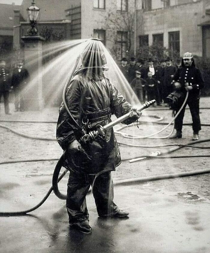 Early 20th century firefighter using innovative water spray gear, showcasing unfamiliar parts of history in firefighting.