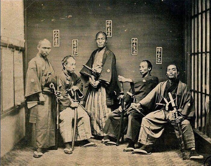 Historic photo of samurai in traditional attire with swords, showcasing unfamiliar parts of history and cultural heritage.