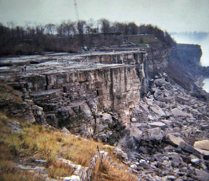 Rocky cliff and shoreline with eroded formations revealing unfamiliar parts of history in nature’s landscape.