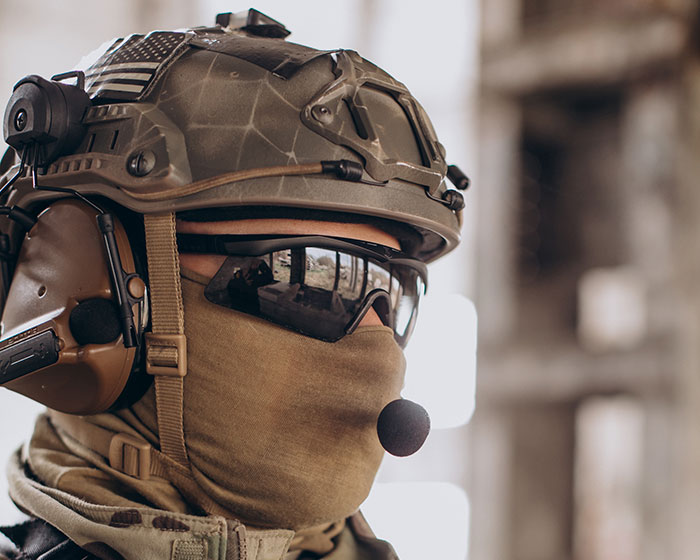 Soldier wearing tactical helmet and headset, showcasing new facts and insights about military gear and technology.