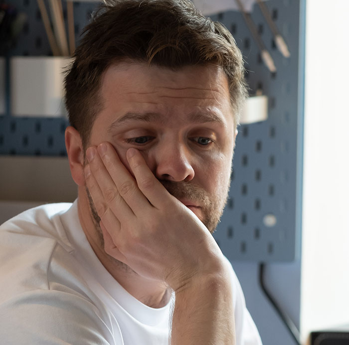 Man looking thoughtful and contemplative, reflecting on new facts he recently learned and wants to share with others.