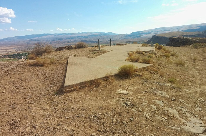 Ancient ruins on a dry hilltop with distant mountains, perfect for discovering new facts about history and nature.