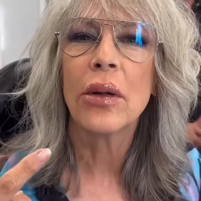 Jamie Lee Curtis with dramatically fuller lips, wearing glasses and showing a new transformation in a close-up image. Jamie Lee Curtis with dramatically fuller lips, wearing glasses and showing a new transformation in a close-up image.
